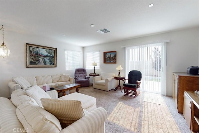 living room featuring light carpet and visible vents