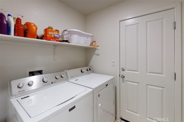 laundry area featuring washing machine and clothes dryer and laundry area