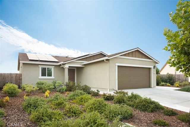 ranch-style home featuring a garage and solar panels