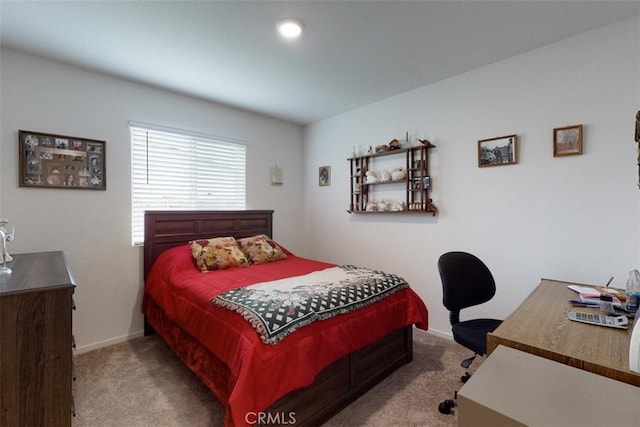 bedroom with baseboards and carpet