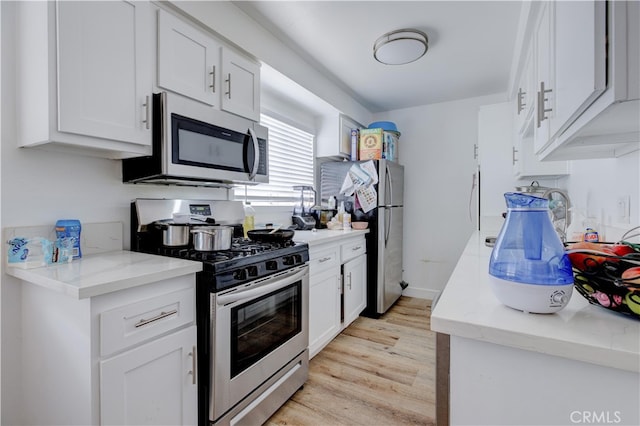 1720 Cerritos Ave Unit 1, Long Beach, CA 90813 - kitchen featuring stainless steel appliances, light wood-style flooring, and white cabinets