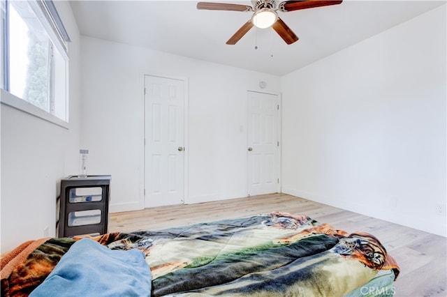 bedroom with hardwood / wood-style floors and ceiling fan