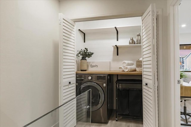 washroom featuring washer / dryer and light hardwood / wood-style floors