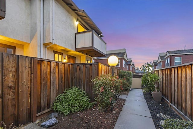 yard at dusk with a balcony