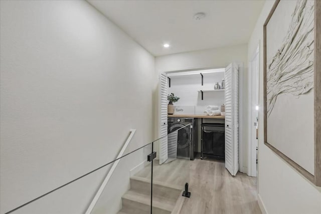 interior space featuring wood-type flooring and washer / dryer