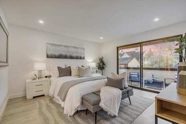 bedroom with access to outside and light hardwood / wood-style floors