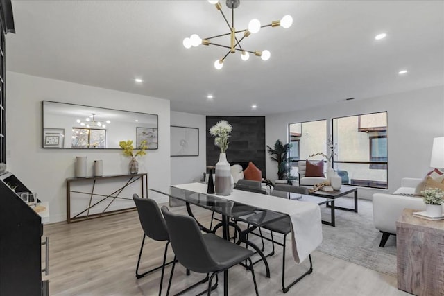 dining area featuring a notable chandelier and light hardwood / wood-style flooring