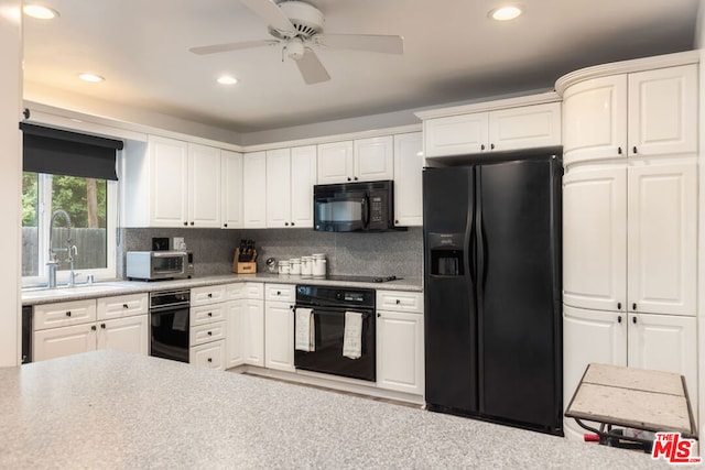 kitchen featuring white cabinetry, decorative backsplash, and black appliances