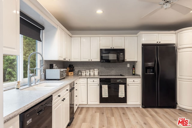 kitchen featuring white cabinetry, sink, backsplash, and black appliances