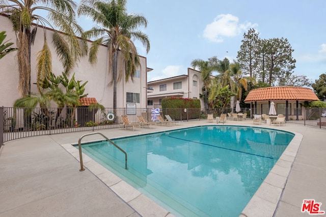 view of swimming pool with a patio