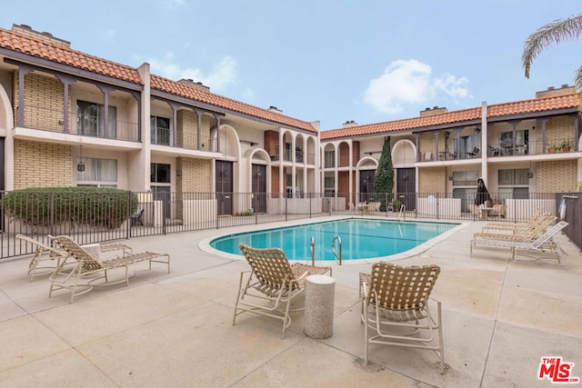 view of swimming pool featuring a patio area