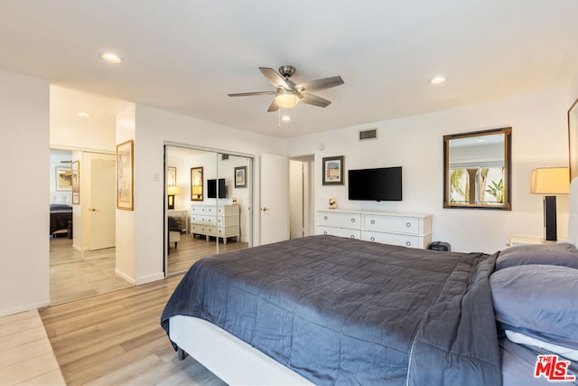 bedroom featuring ceiling fan, light hardwood / wood-style floors, and a closet