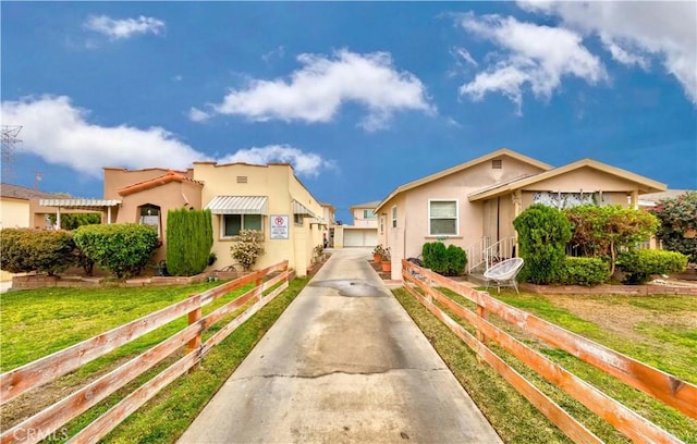 view of front of house featuring a garage and a front lawn