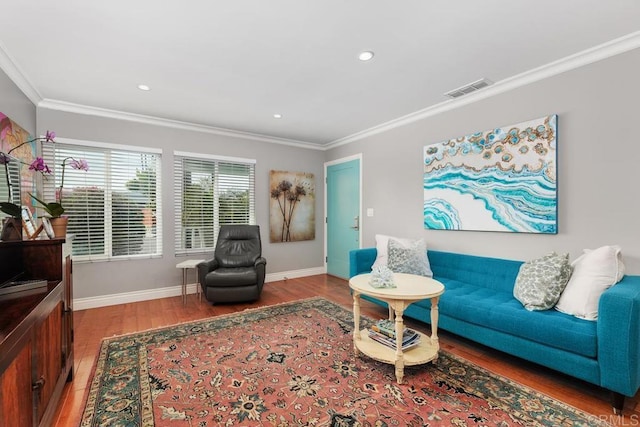 living room featuring hardwood / wood-style flooring and ornamental molding