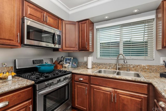 kitchen with a healthy amount of sunlight, ornamental molding, stainless steel appliances, and sink