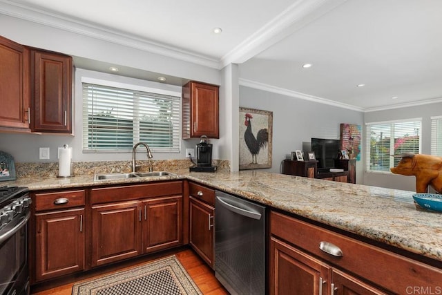 kitchen with sink, ornamental molding, stainless steel appliances, and light wood-type flooring