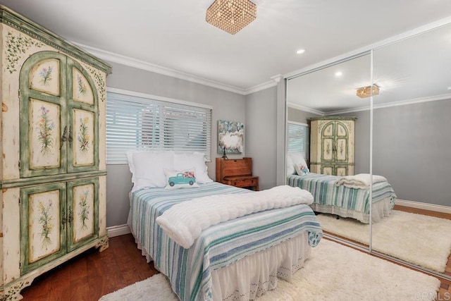 bedroom with crown molding and dark hardwood / wood-style floors