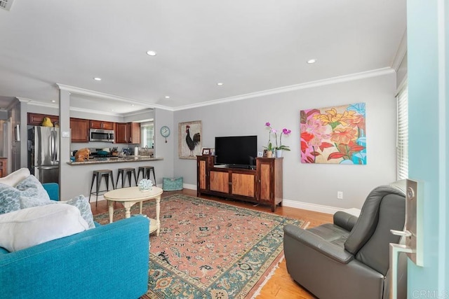 living room with ornamental molding and light hardwood / wood-style flooring