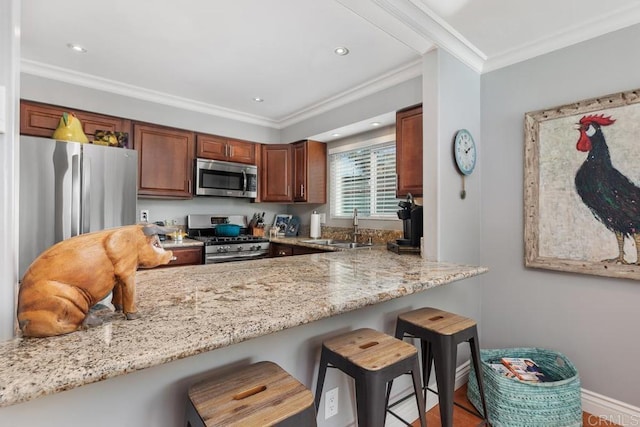 kitchen featuring a kitchen bar, sink, kitchen peninsula, stainless steel appliances, and light stone countertops