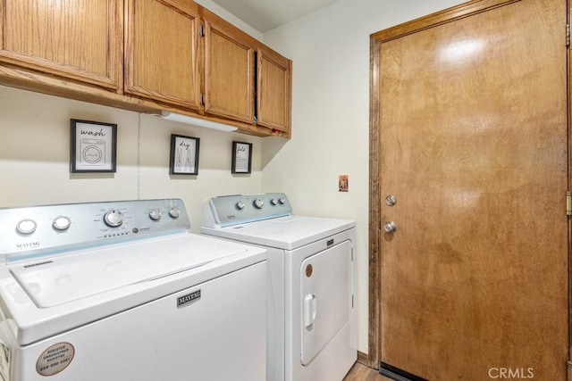 laundry room with cabinets and separate washer and dryer