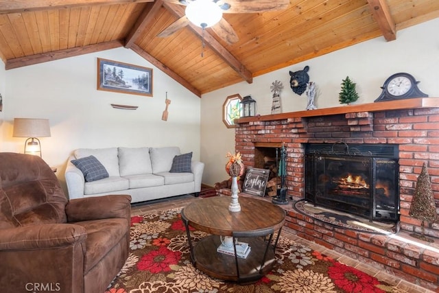 living room featuring a brick fireplace, lofted ceiling with beams, wooden ceiling, and ceiling fan