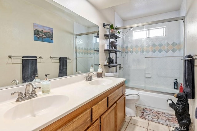 full bathroom with tile patterned flooring, bath / shower combo with glass door, vanity, and toilet