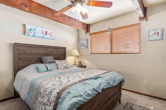 bedroom featuring beamed ceiling, light colored carpet, and ceiling fan