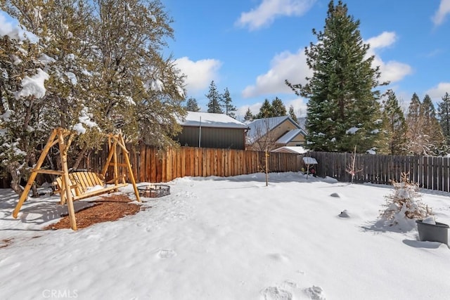 view of yard layered in snow