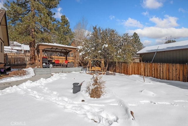 yard covered in snow with a gazebo