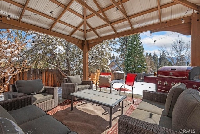 snow covered patio with a gazebo, area for grilling, and outdoor lounge area