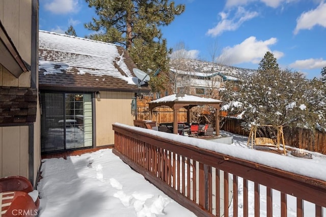 snow covered deck featuring a gazebo