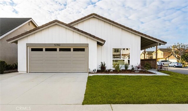 view of front of property with a garage and a front yard