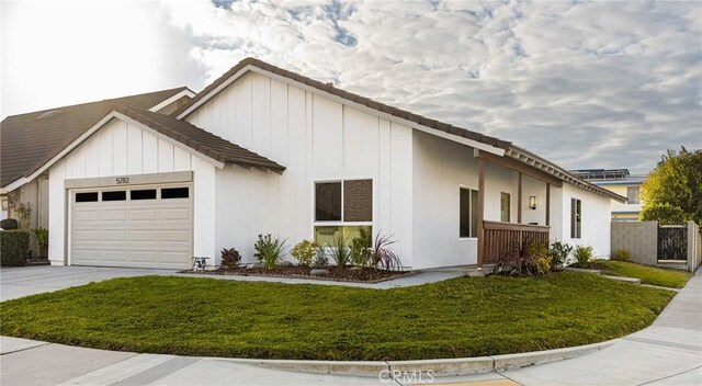 view of front of house with a garage and a front lawn