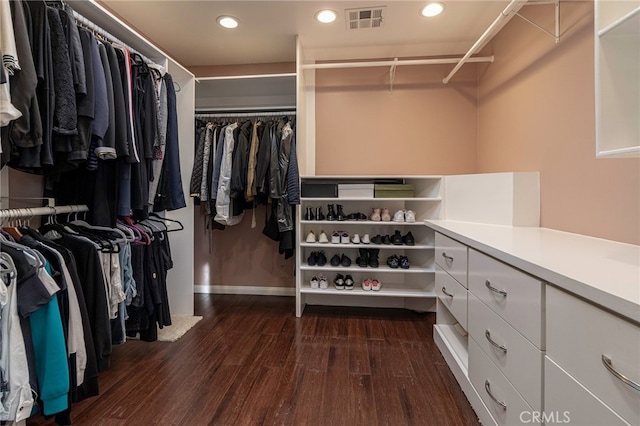 spacious closet featuring dark wood-style floors and visible vents