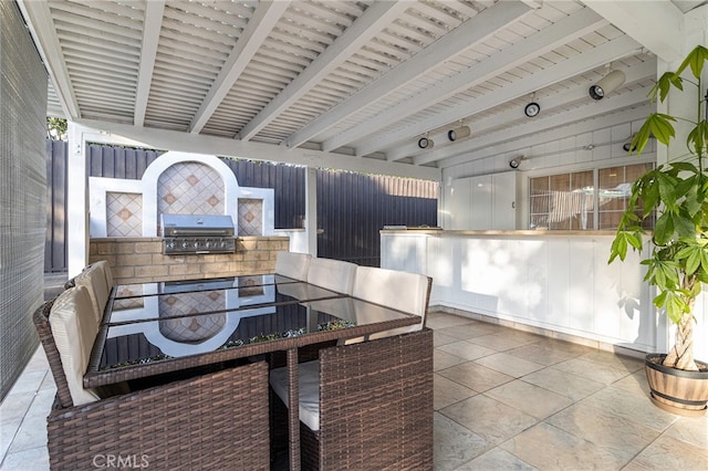 dining space featuring beam ceiling