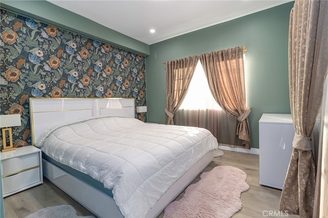 bedroom with recessed lighting, baseboards, and wood finished floors