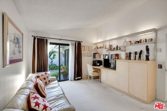 carpeted living room featuring lofted ceiling and a textured ceiling