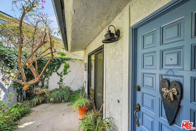 doorway to property with a patio area