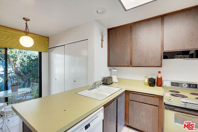 kitchen featuring sink, decorative light fixtures, range with electric stovetop, kitchen peninsula, and dishwasher