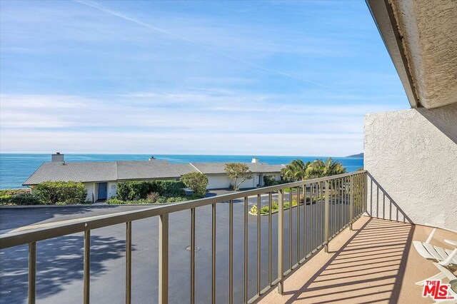 balcony featuring a water view