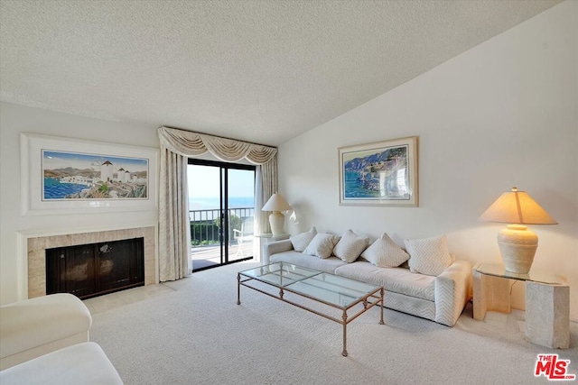 living room with lofted ceiling, light carpet, a textured ceiling, and a fireplace