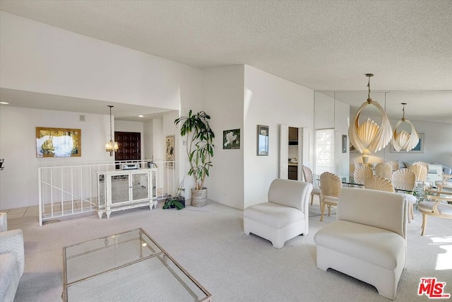 living room with lofted ceiling, carpet flooring, and a textured ceiling