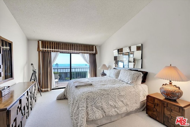 carpeted bedroom featuring vaulted ceiling, a water view, access to outside, and a textured ceiling