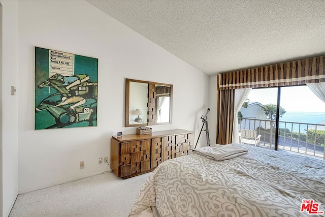 bedroom with lofted ceiling, a water view, a textured ceiling, access to outside, and carpet flooring