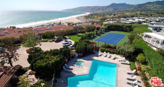 drone / aerial view featuring a water view and a view of the beach