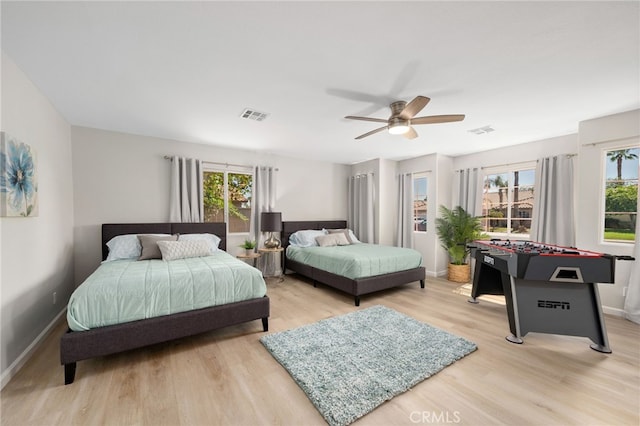 bedroom with ceiling fan and light wood-type flooring