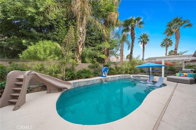 view of swimming pool with a water slide and a pergola