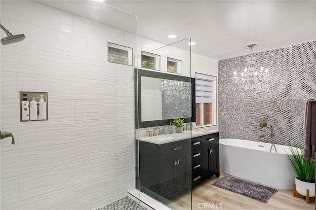 bathroom featuring vanity, separate shower and tub, wood-type flooring, and tile walls