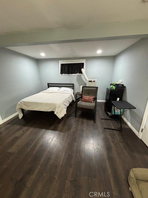 bedroom with dark hardwood / wood-style floors