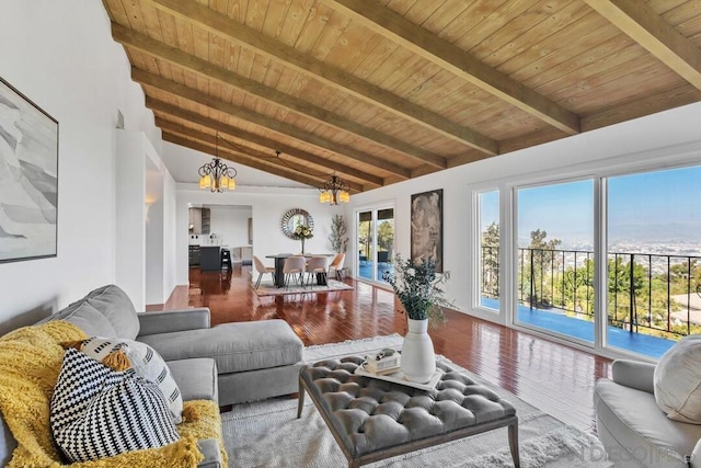 living room featuring hardwood / wood-style flooring, vaulted ceiling with beams, a notable chandelier, and wood ceiling